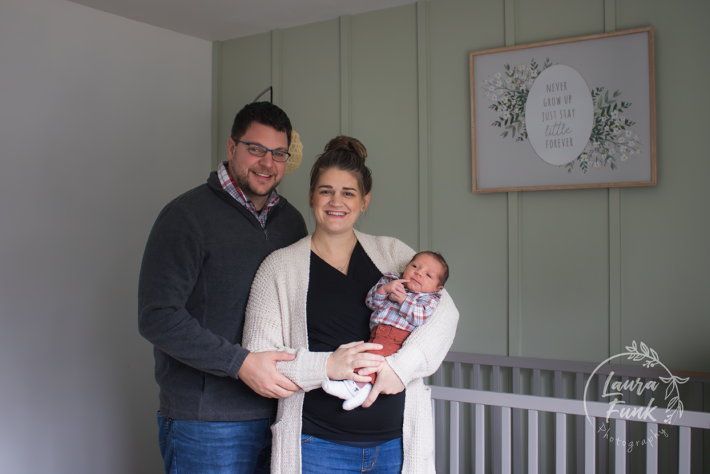 Mother and father holding newborn in nursery