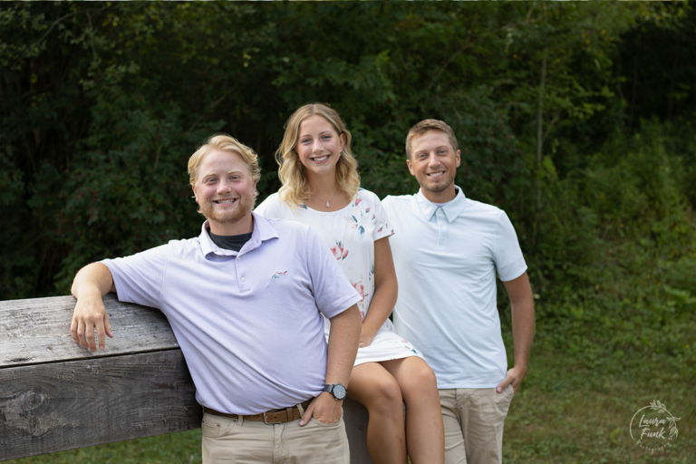 sibling posing in a park for Laura Funk Photography