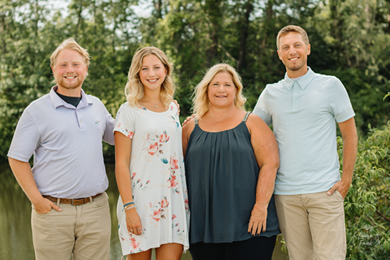 family of 4 posing in the park