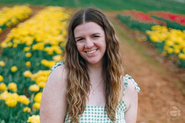 girl standing in a tulip farm in Alabama