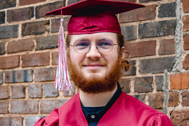 close up of cap and gown of a boy graduating from High School