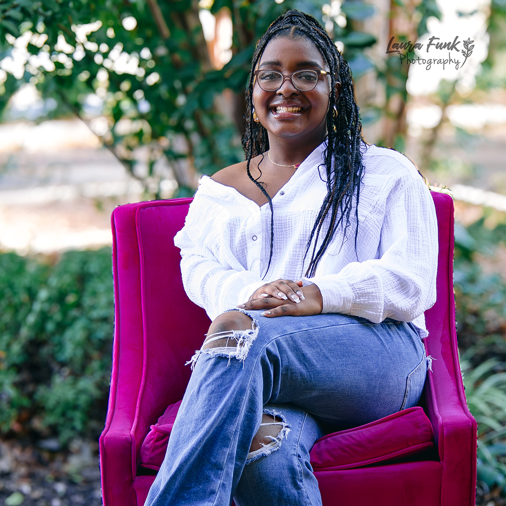 a girl in a pink chair posing for her 16th birthday