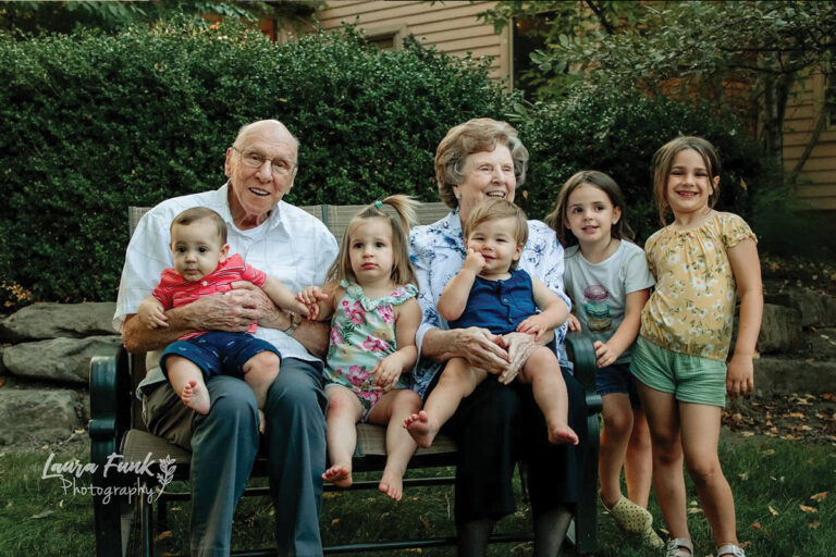 grandparents holding thier grandchildren for a picture