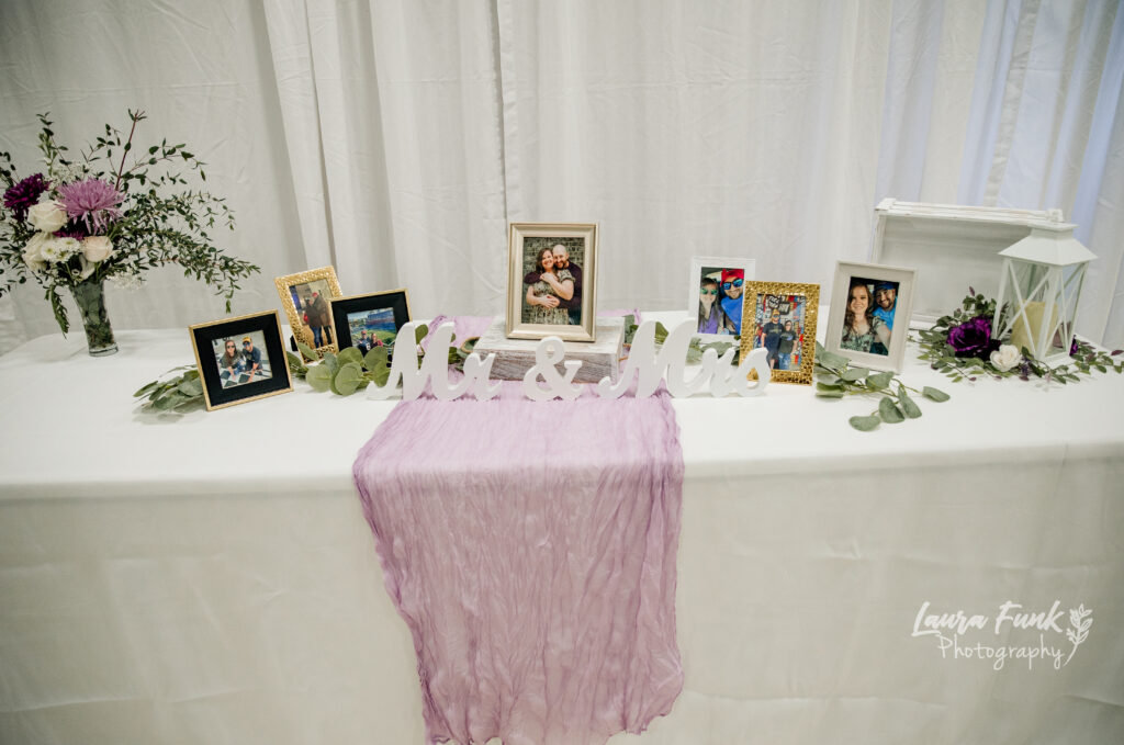 Wedding table filled with couple photos. Laura Funk