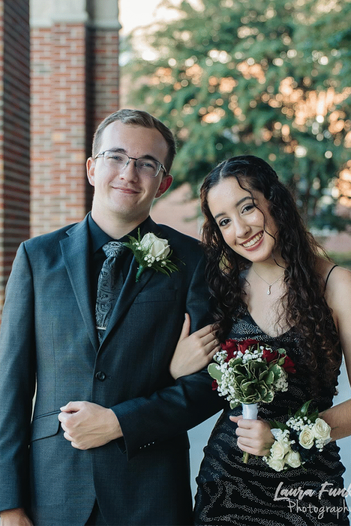 homecoming dance couple taking photo befroe dance