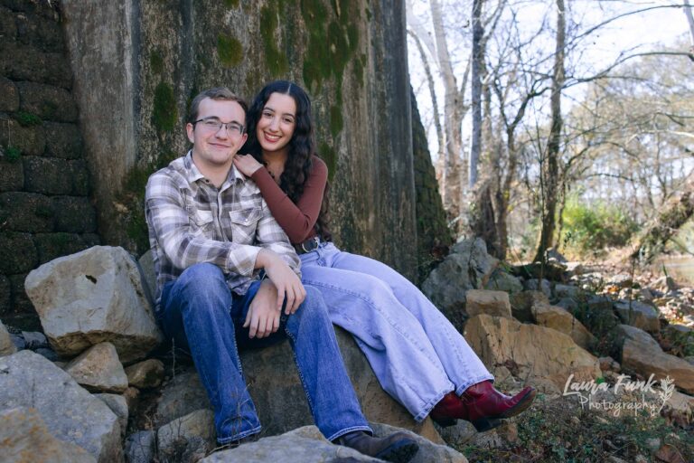 couple sitting next to tree for a engagement photo