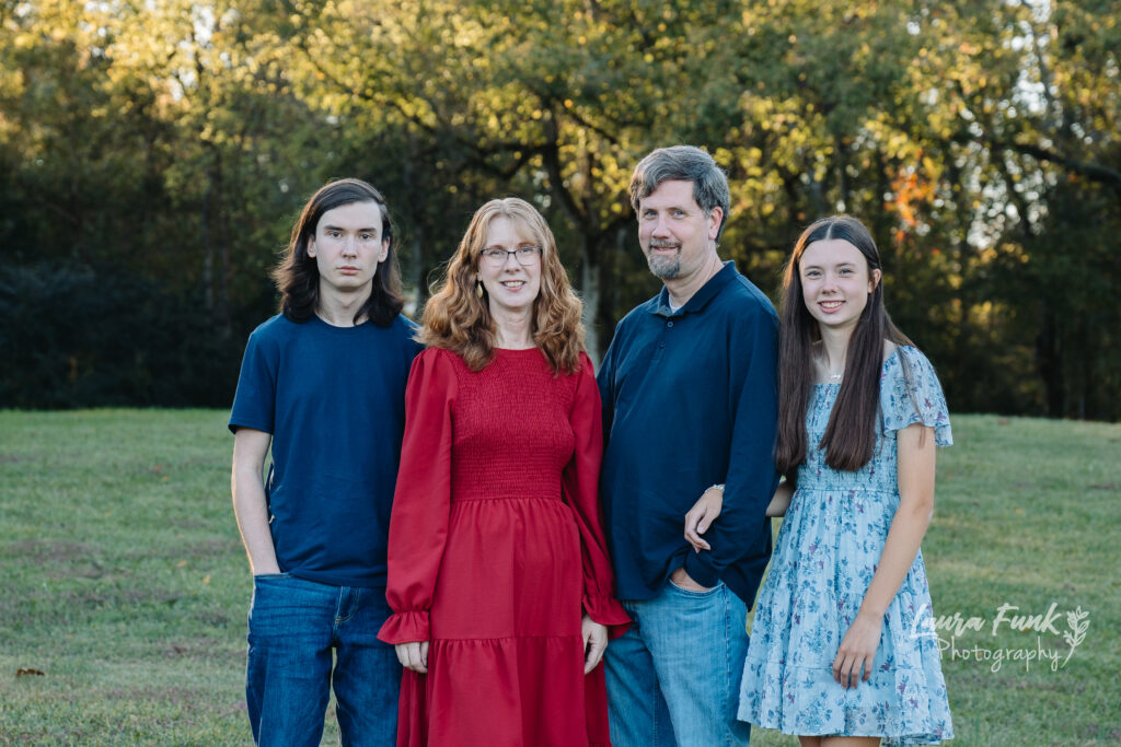 family photo standing in the meadows of a park